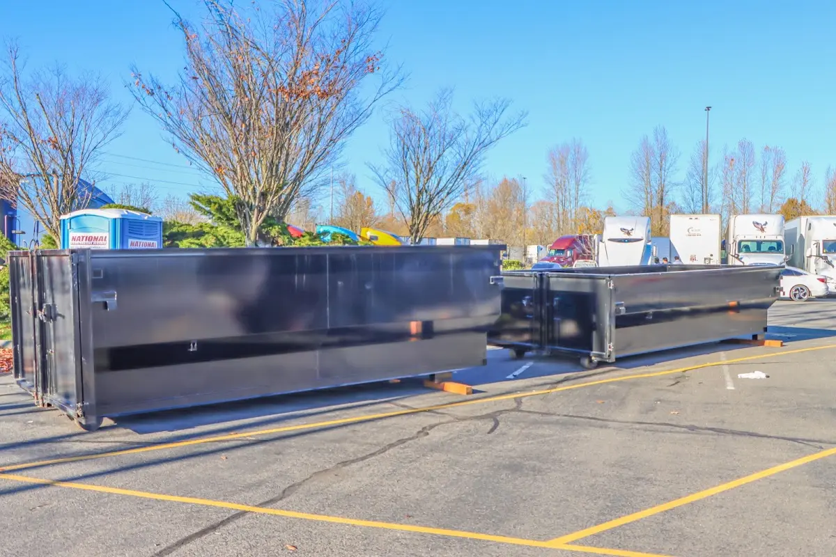 Professional dumpster rental service with roll-off container on residential driveway in Piedmont